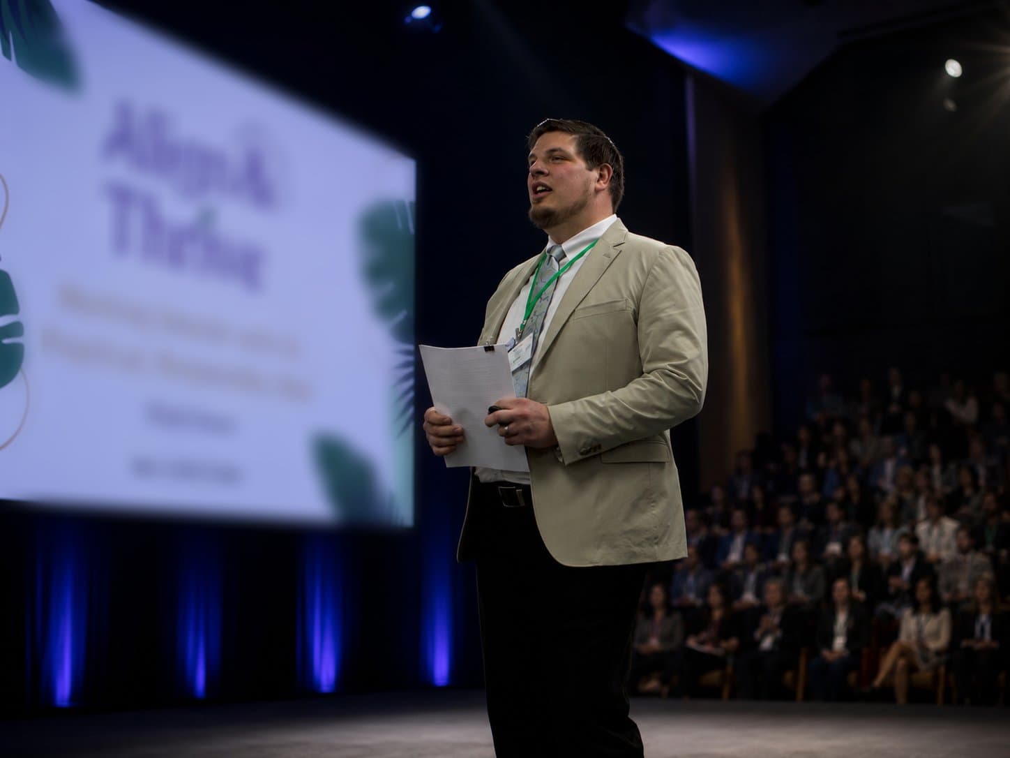 Elijah Desent on stage delivering the talk Working Smarter with AI to a corporate audience