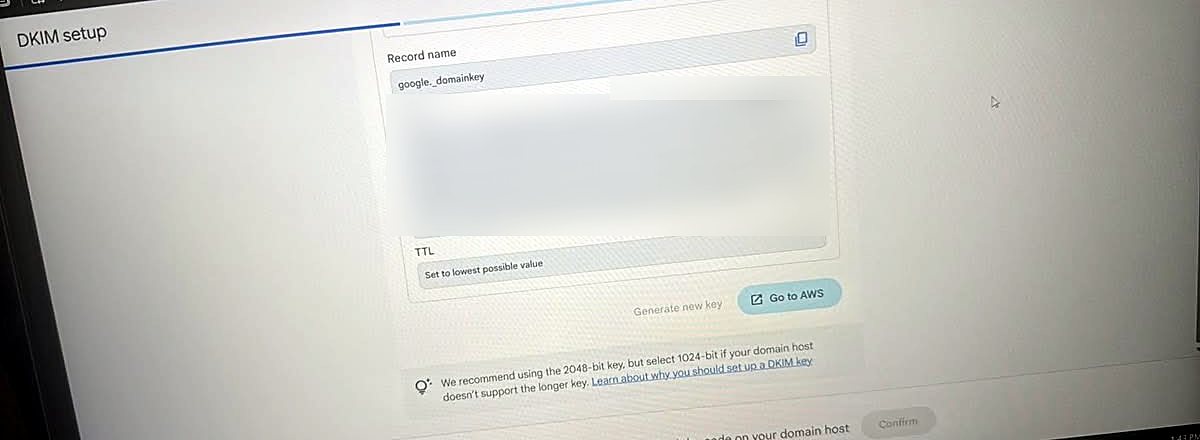 DKIM key generated, showing Record name google._domainkey, a long key value (blurred), TTL set to lowest possible value, and a Go to AWS button.