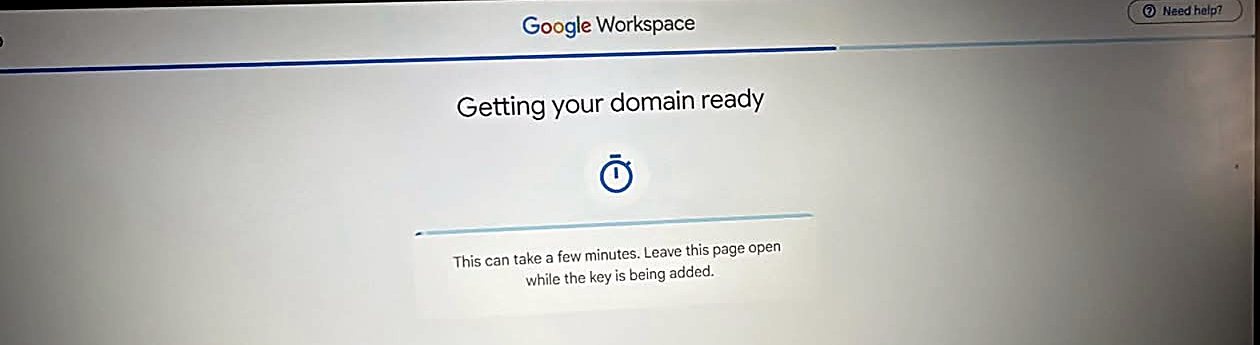 Google Workspace screen reading 'Getting your domain ready' with a timer icon: This can take a few minutes. Leave this page open while the key is being added.